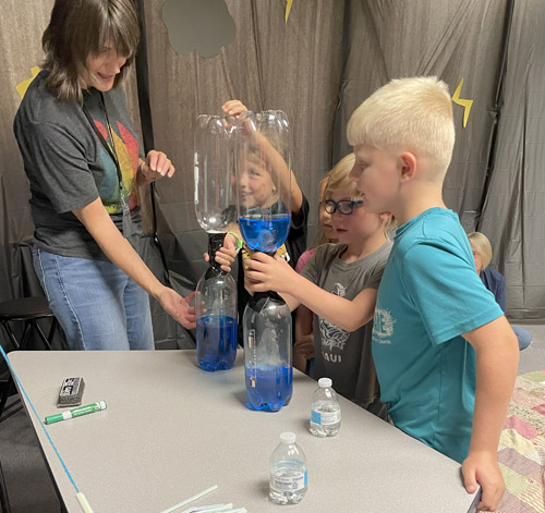 science - exploring vortices with colored water and a "tornato tube"